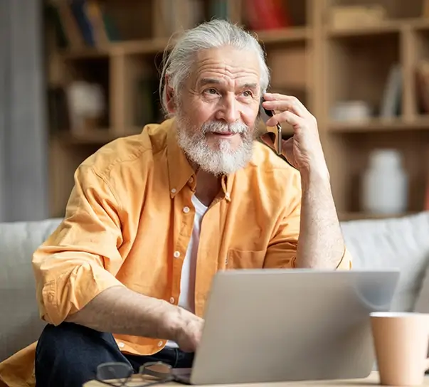 Man with laptop on a phone call