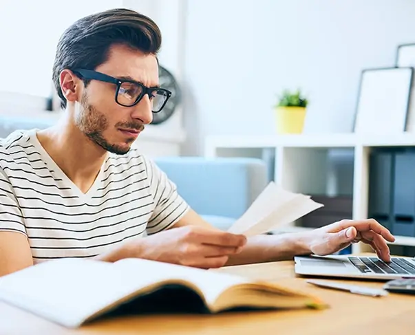 Man looking at paperwork - Energy Bills
