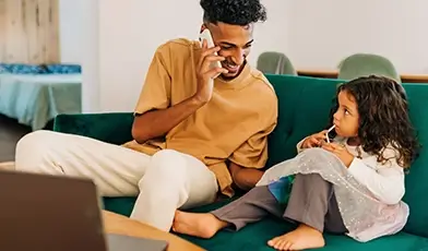 Two People on a Sofa Making a Phone Call